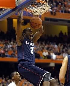 Connecticut's Stanley Robinson dunks against Syracuse  during the first half of an NCAA college basketball game in Syracuse, N.Y. , Wednesday, Feb. 10, 2010.