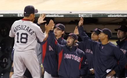 Boston Red Sox's Daisuke Matsuzaka is congratulated by his team-mates after being relieved in the seventh inning of their MLB American League baseball game against the Oakland Athletics in Oakland, California  July 19, 2010.