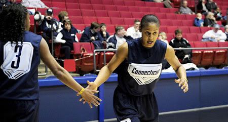 UConn's Tiffany Hayes, left, gives a hand to Maya Moore during practice Saturday in Dayton, Ohio, the day before the undefeated put their 74-game winning streak on the line in a Sweet 16 game against Iowa State. 