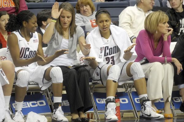 UConn's Tiffany Hayes, left, Caroline Doty, center, and Maya Moore celebrate on the bench in the second half with the Huskies in control. 