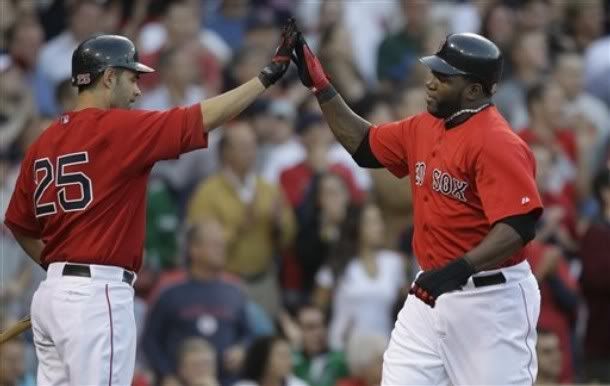 Boston  Red Sox designated hitter David Ortiz, right, is congratulated by teammate Mike Lowell, left, after scoring on a double by Adrian Beltre in the first inning against the Philadelphia Phillies during their baseball game in Boston, Friday June 11, 2010 - AP Photo