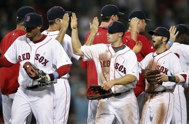 Boston  Red Sox players, foreground from left, Darnell McDonald, Daniel Nava and Dustin Pedroia celebrate their 2-0 win after the ninth inning of a baseball game against the Los Angeles Dodgers, Sunday, June 20, 2010, in Boston - AP Photo