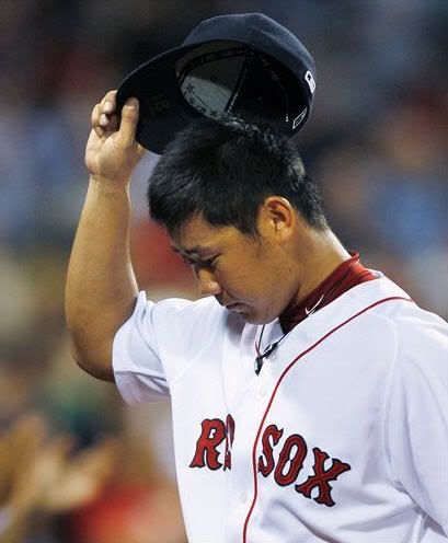 Boston Red Sox pitcher Daisuke Matsuzaka tips his cap to the crowd as he leaves during the seventh inning of a baseball game against the Oakland Athletics at Fenway Park in Boston, Wednesday, June 2, 2010. (AP Photo/Charles Krupa)