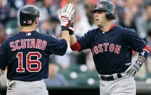 Boston Red Sox's Dustin Pedroia, right, gets a high-five from teammate Marco Scutaro after hitting a two-run home run against the Detroit Tigers in the first inning of a baseball game Friday, May 14, 2010, in Detroit. (AP Photo/Duane Burleson)