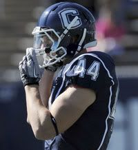 UConn running back Robbie Frey buttons up his chin strap in preparation for a big afternoon against Vanderbilt. 