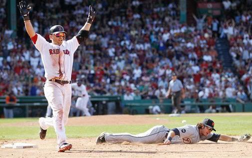 Boston Red Sox's Marco Scutaro, left, celebrates his game-winning bunt-single which scored the winning run on a throwing error by Detroit Tigers pitcher Robbie Weinhardt that second baseman Will Rhymes, right, could not handle at first base during the ninth inning of Boston's 4-3 win in a baseball game at Fenway Park in Boston, Sunday, Aug. 1, 2010. (AP Photo/Winslow Townson)