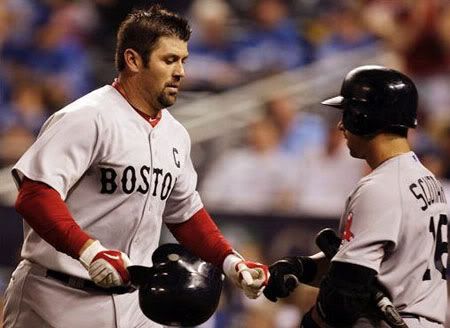 Boston Red Sox's Jason Varitek, left, is congratulated by teammate Marco Scutaro after a solo home run during the ninth inning of a baseball game against the Kansas City Royals, Saturday, April 10, 2010, in Kansas City, Mo. It was the second home run of the game for Varitek. The Red Sox defeated the Royals 8-3. (AP Photo/Orlin Wagner)