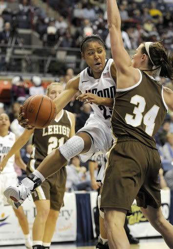 Maya Moore dishes the ball to Tiffany Hayes around Lehigh's Alexa Williams during the first half at Gampel Pavilion. Moore scored 24 of her game-high 29 points in the first half. 