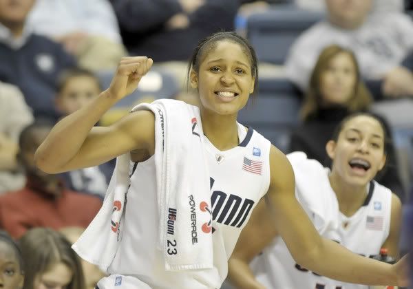 Maya Moore, left, and Bria Hartley cheer on the team late in the second half after both sat out the last couple of minutes. The University of Connecticut beat LSU in the final game of the World Vision Challenge at the Gampel Pavilion in Storrs Sunday afternoon by a score of 81 to 51. 