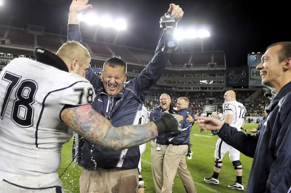 UConn head coach Randy Edsall gets soaked by Zach Hurd after the Huskies beat the University of South Florida 19-16 at the Raymond James Stadium in Tampa Saturday for the last game of the regular season. With the win, they have earned a BCS berth.