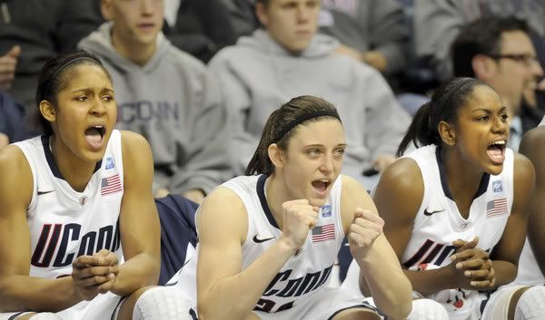 Maya Moore, Kelly Faris and Tiffany Hayes (left to right) cheer from the bench in the final seconds of UConn's 79-47 victory over Marquette Thursday at Gampel Pavilion. Moore scored 31 points, and Hayes had 16. 