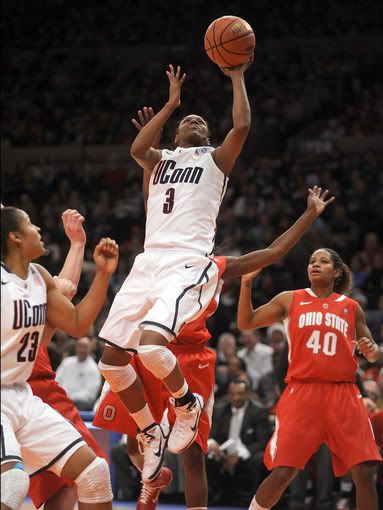 Tiffany Hayes of UCon drives past Brittany Johnson and the Ohio State defense for two of her 17 first half points as the Huskies lead 40-26 at the half in the Maggie Dixon Classic at Madison Square Garden in New York. UConn was going for its 88th consecutive victory. 