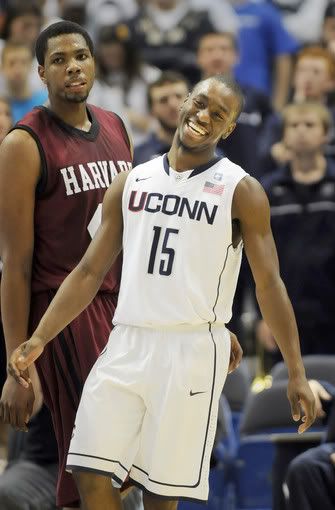 UConn's Kemba Walker is all smiles near the end of the game, but Harvard's Keith Wright is not during the second half of the Huskies' 81-52 victory Wednesday night at the XL Center. Walker had a game-high 20 points. 