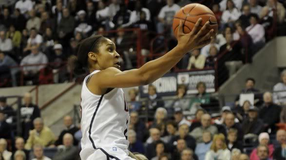 Connecticut's Maya Moore, top, jumps past Marquette's Paige Fiedorowicz for a shot in the first half of an NCAA college basketball game at Storrs, Conn., Thursday, Dec. 9, 2010.