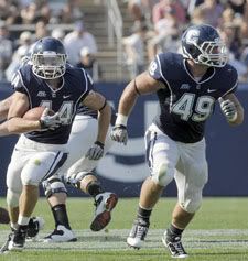 Robbie Frey, with teammate Scott McCummings behind him defending against Imani Chatman of Buffalo and teammate Anthony Sherman running alongside, led the game in rushing with 113 net yards. UConn defeated Buffalo 45-21. (Mark Mirko, Hartford Courant) 