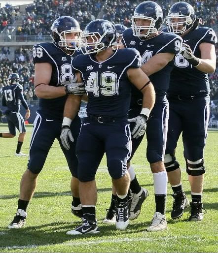 Anthony Sherman #49 of the Connecticut Huskies is congratulated by teammates John Delahunt #89 and Ryan Griffin #94 after Sherman scored a touchdown in the first quarter against Cincinnati Bearcats defends on November 27, 2010 at Rentschler Field in East Hartford, Connecticut. 