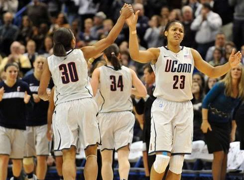 Connecticut's Maya Moore, right, high fives teammate Lorin Dixon after breaking UConn's all time scoring record in the first half of an NCAA college basketball game in Hartford, Conn., Sunday, Dec. 5, 2010.