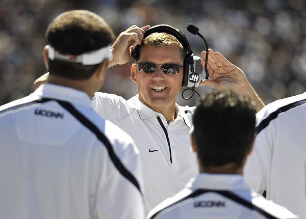 Head coach Randy Edsall smiles at his staff during the first half. 