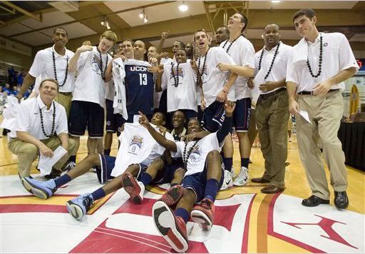 The Connecticut basketball team and coaching staff poses for a picture after defeating Kentucky 84-67 to win the Maui Invitational in Lahaina, Hawaii, Wednesday, Nov. 24, 2010. Connecticut's Kemba Walker was named the tournament most valuable player.