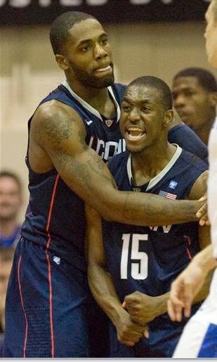 Connecticut's Alex Oriakhi gives Kemba Walker (15) a hug after Walker was fouled by Kentucky guard DeAndre Liggins in the first half of an NCAA college basketball game at the Maui Invitational in Lahaina, Hawaii, Wednesday, Nov. 24, 2010.