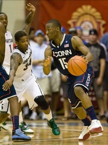 Michigan State guard Korie Lucious (34) attempts to defend Connecticut guard Kemba Walker (15) in the second half of an NCAA college basketball game at the Maui Invitational in Lahaina, Hawaii Tuesday, Nov. 23, 2010. Connecticut defeated Michigan State 70-67 to advance to the championship game.