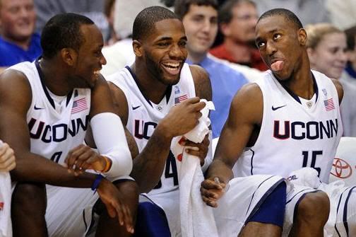 Connecticut's Kemba Walker, right, jokes with teammates Alex Oriakhi, center, and Donnell Beverly late in Connecticut's 94-61 victory over UMBC in their NCAA college basketball game in Hartford, Conn., on Friday, Dec. 3, 2010. Walker had a triple double in the win with 24 points, 13 rebounds, and 10 assists. (AP Photo/Fred Beckham)