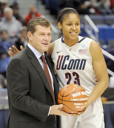 The University of Connecticut's women's basketball head coach Geno Auriemma presents Maya Moore with a basketball commemorating her 1,000 career rebound in a game against LSU on November 28. The presentation took place before the start of UConn's matchup against Sacred Heart University during which Moore surpassed Tina Charles to become UConn's all-time leading scorer in the first half of the game, scoring her 2,347th point.
