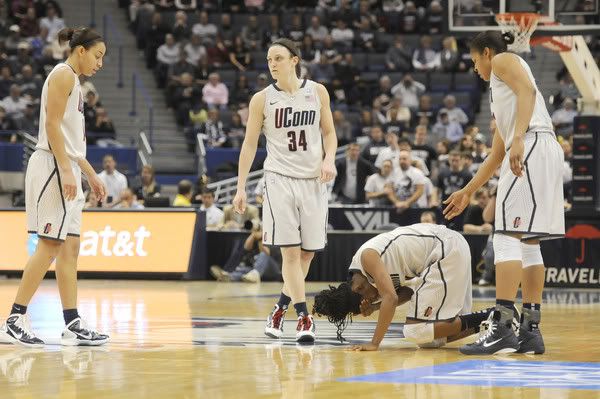 UConn's Tiffany Hayes holds her head after hitting the floor hard in the first half.