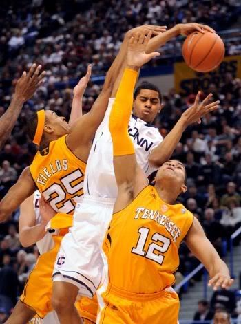 Connecticut's Jeremy Lamb, center, fights for a rebound with Tennessee's John Fields, left, and Tobias Harris during the first half of their NCAA college basketball game, Saturday, Jan. 22, 2011, in Hartford, Conn.