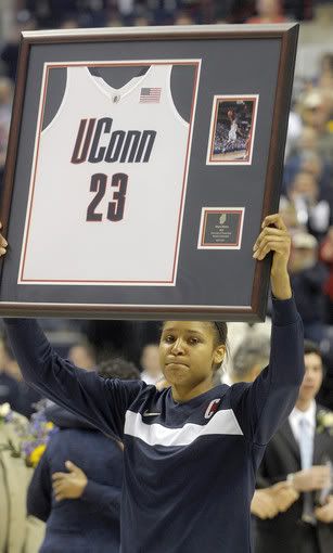 Connecticut Huskies forward Maya Moore (23), raises her jersey to the fans after receiving it as part of senior night ceremonies. The University of Connecticut woman's basketball team played Syracuse University at Gampel Pavilion in Storrs. The game was also Seniors night, the last regular season game scheduled at Storrs, and Maya Moore and Lorin Dixon were presented with jerseys. 