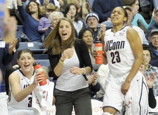The University of Connecticut's Stefanie Dolson, Caroline Doty and Maya Moore celebrate after a late second-half basket by Kelly Faris in their Big East game against DePaul at Gampel Pavilion. UConn cruised to the win, 89-66. 