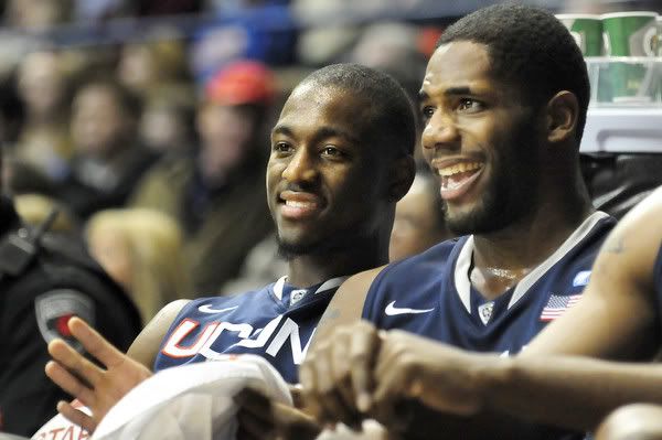 UConn's Kemba Walker, left, and Alex Oriakhi joke on the bench in the second half as the Huskies cruised past DePaul Saturday in Rosemont, Ill. 