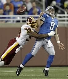 Washington Redskins linebacker Andre Carter (99) hits Detroit Lions quarterback Matthew Stafford (9), jarring the ball loose, during the first quarter of their NFL football game in Detroit, Sunday, Oct. 31, 2010.