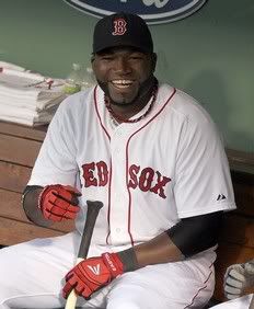 David Ortiz #34 enjoys a light moment in the dugout before a game against the Cleveland Indians at Fenway Park on August 2, 2011 in Boston, Massachusetts.