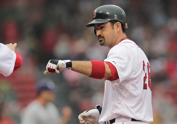 Adrian Gonzalez #28 of the Boston Red Sox reacts after he reaching base on the second of a four-hit game against the San Diego Padres at Fenway Park on June 22, 2011 in Boston, Massachusetts.