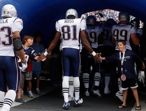 Randy Moss #81 of the New England Patriots enters the field before the NFL season opener against the Cincinnati Bengals at Gillette Stadium on September 12, 2010 in Foxboro, Massachusetts.