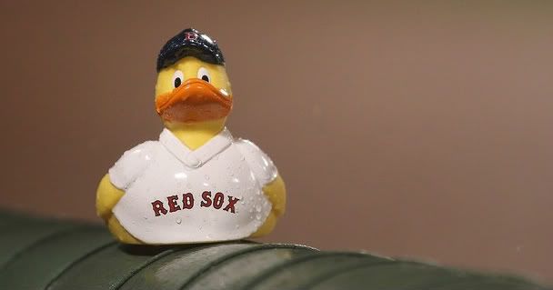 A rubber duck sits of a railing during a rain delay of a game between the Oakland Athletics and the Boston Red Sox at Fenway Park August 27, 2011 in Boston, Massachusetts.