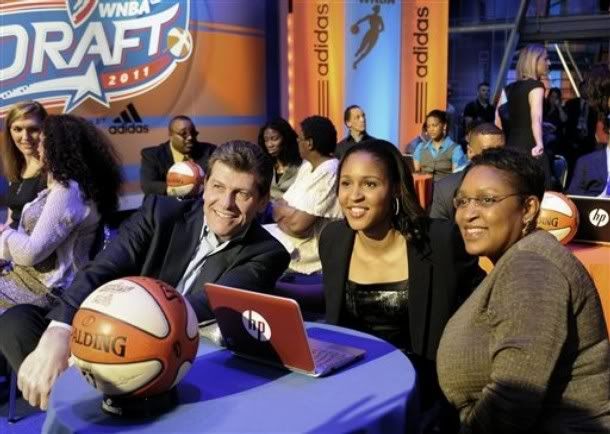 Connecticut's Maya Moore, center, sits with UConn coach Geno Auriemma, left, and her mother, Kathryn Moore, prior to being chosen by the Minnesota Lynx with the No. 1 pick in the WNBA basketball draft in Bristol, Conn. , Monday, April 11, 2011.