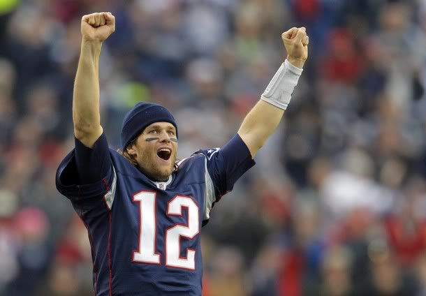 New England Patriots quarterback Tom Brady celebrates from the sideline after the Patriots scored a touchdown against the Miami Dolphins in the second half of their NFL football game in Foxborough, Massachusetts January 2, 2011.