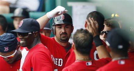 Boston Red Sox' Adrian Gonzalez(notes), center, is congratulated by teammates after his solo home run against the Tampa Bay Rays during the fourth inning of a spring training baseball game in Fort Myers, Fla., Tuesday, March 29, 2011.