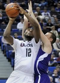 Connecticut's Andre Drummond (12) is fouled by Holy Cross' Jordan Stevens during the second half of an NCAA college basketball game in Hartford, Conn., on Sunday, Dec. 18, 2011.