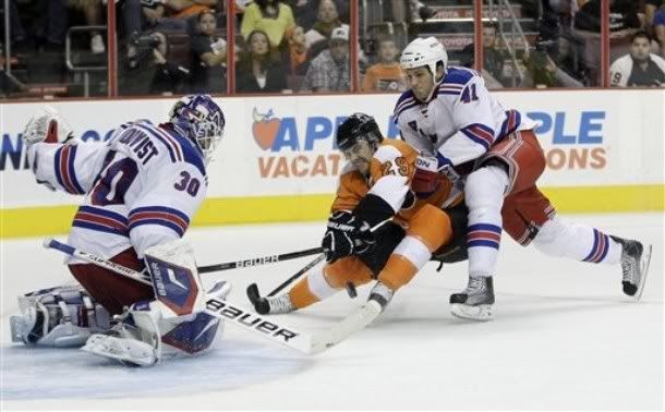 Philadelphia Flyers' Harry Zolnierczyk (29) tries to get a shot past New York Rangers goalie Henrik Lundqvist (30), of Sweden, and Stu Bickel (41) in the second period of a preseason NHL hockey game, Monday, Sept. 26, 2011, in Philadelphia.