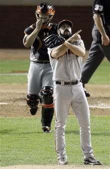 San Francisco Giants' Brian Wilson reacts after the Giants won Game 4 of baseball's World Series 4-0 against the Texas Rangers Sunday, Oct. 31, 2010, in Arlington, Texas. Buster Posey joins Wilson on the mound.