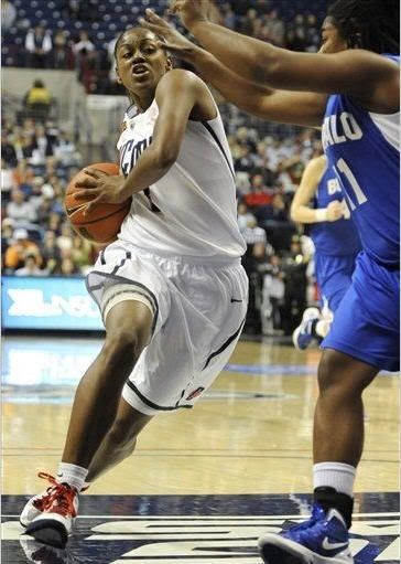 Connecticut's Tiffany Hayes drives to the basket while guarded by Buffalo's Ephesia Holmes, right, in the first half of an NCAA college basketball game in Storrs, Conn., Saturday, Nov. 26, 2011.