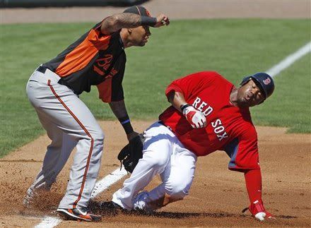 Boston Red Sox base runner Carl Crawford(notes), right, beats the tag by Baltimore Orioles third baseman Josh Bell(notes) as he safely steals third in the second inning of an MLB spring training baseball game in Fort Myers, Fla., Monday, March 7, 2011.