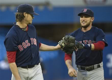 Boston Red Sox starting pitcher Clay Buchholz(notes), left, celebrates with Red Sox shortstop Jed Lowrie(notes), right, while walking back to the dugout to end the second inning against the Toronto Blue Jays during the first inning of a baseball game on Friday, June 10, 2011.