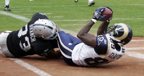 St Louis Rams Mark Clayton (R) makes a touch down past Oakland Raiders Tyvon Branch in the second half of their NFL football game in Oakland, California, September 19, 2010.