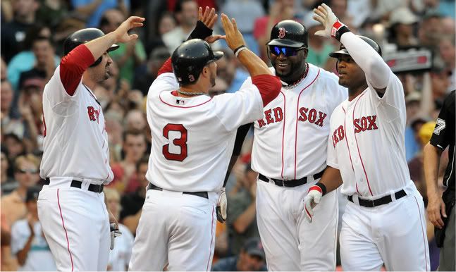 Carl Crawford(notes) #13 of the Boston Red Sox (R) is congratulated by teammates Adrian Gonzalez(notes) #28 (L), Mike Aviles(notes) #3, and David Ortiz(notes) #34 after hitting a grand slam in the fourth inning against the Texas Rangers at Fenway Park on September 3, 2011 in Boston, Massachusetts. 