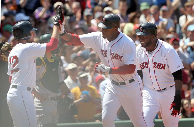 Carl Crawford(notes) #13 of the Boston Red Sox celebrates his three-run home run with teammates Jed Lowrie(notes) #12 and David Ortiz(notes) #34 against the Oakland Athletics at Fenway Park on June 5, 2011 in Boston, Massachusetts. 