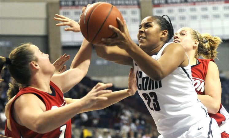 UConn's Kaleena Mosqueda-Lewis tries to get a shot off against Dayton defenders Samantha MacKay, left, and Elle Queen in the World Vision Classic Sunday.